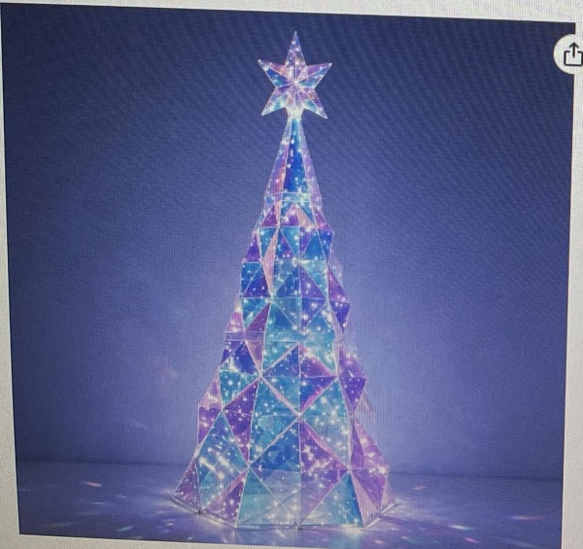 Giant outdoor prismatic iridescent Christmas tree lit with blue, purple, and white LEDs